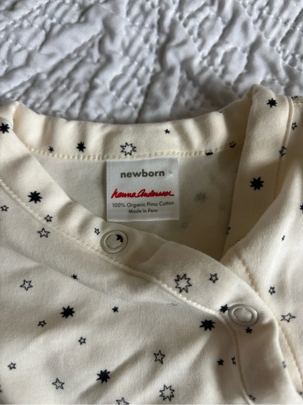Hanna Andersson Cream Newborn Jumpsuit with Black Star Print